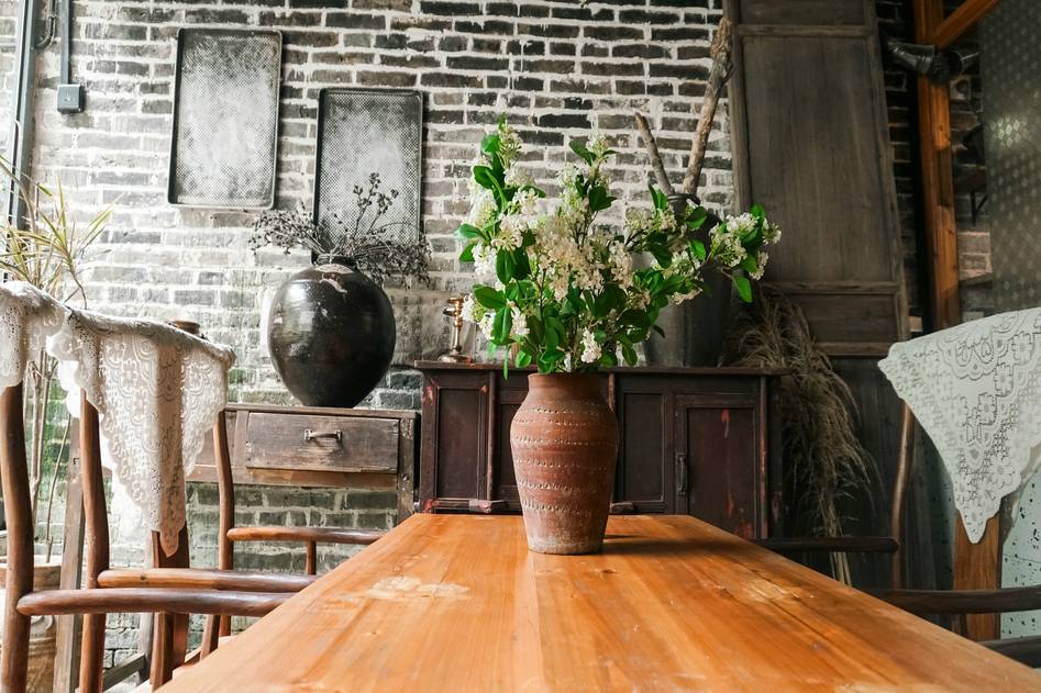 Rustic farmhouse dining table with wooden chairs and neutral decor