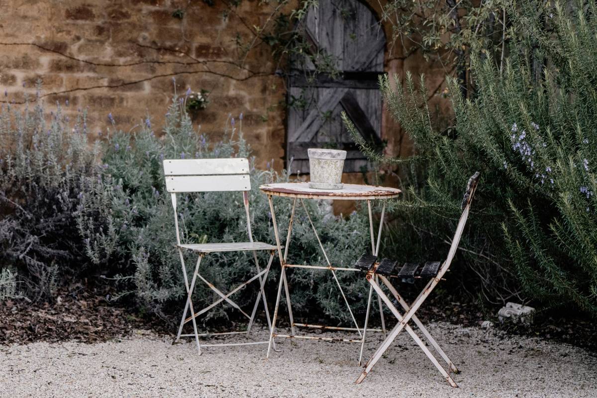 close-up of weathered farmhouse style garden furniture showing hand-cut joinery and natural wood grain